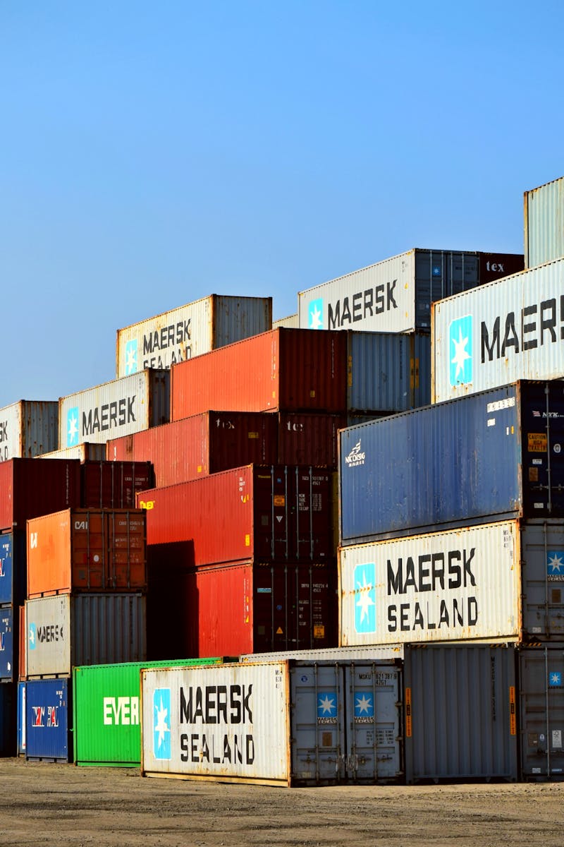 Colorful stacked shipping containers at a port exemplify global logistics.